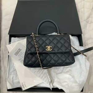 Black Coco Chanel flap bag top handle caviar medium gold hardware.